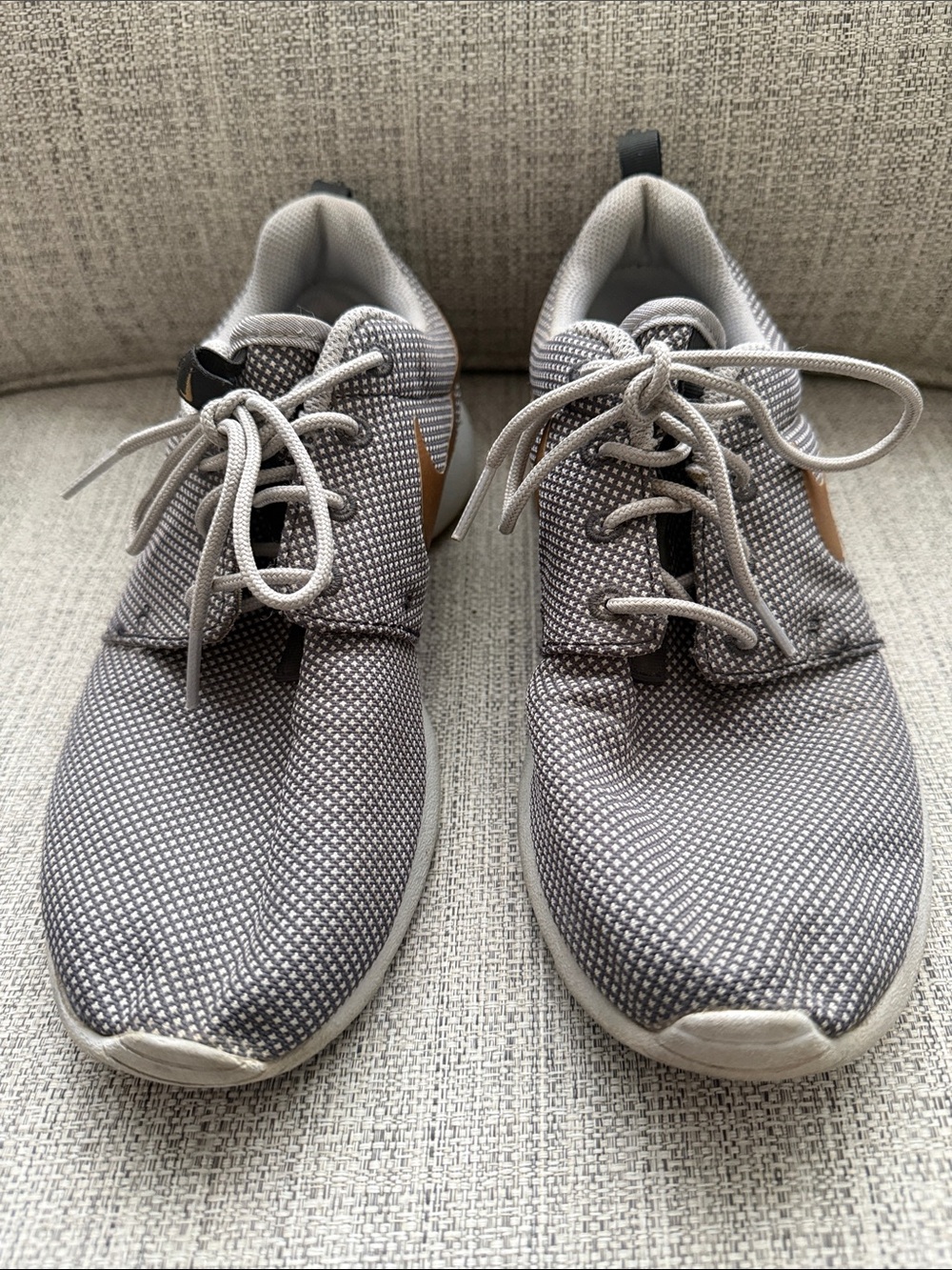 Women’s Nike Roshe gray with gold swoosh, size 7.5